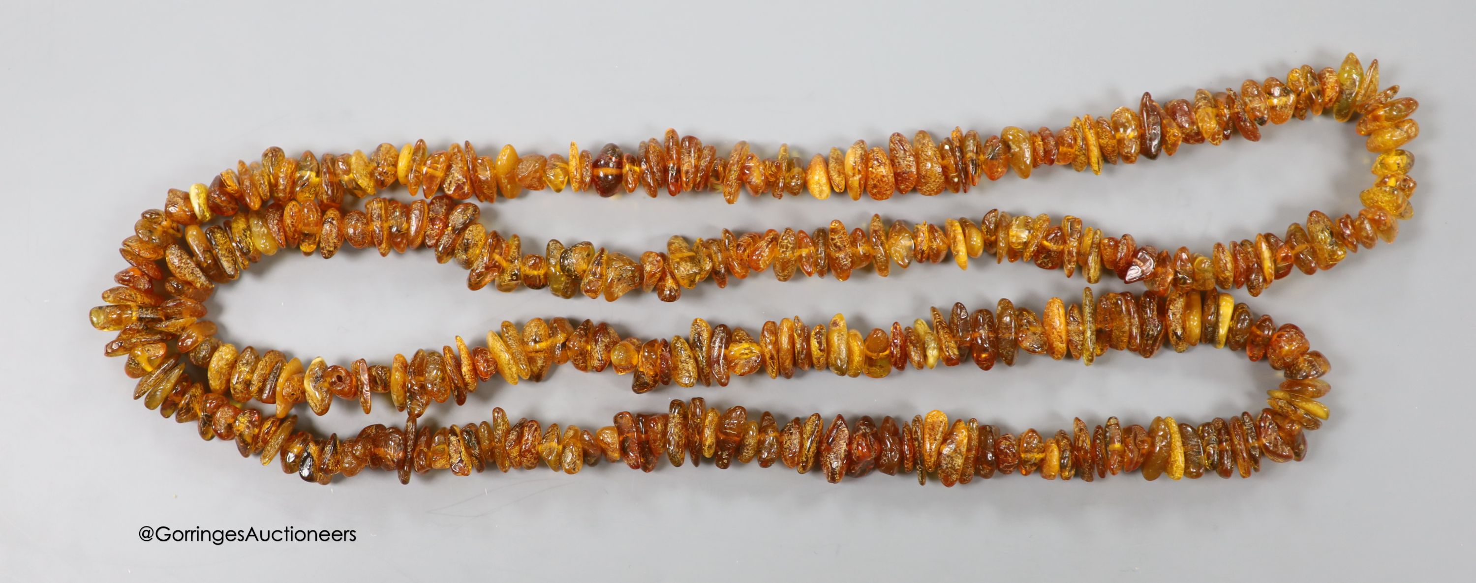 A single strand amber pebble necklace, 98cm, gross 56 grams.